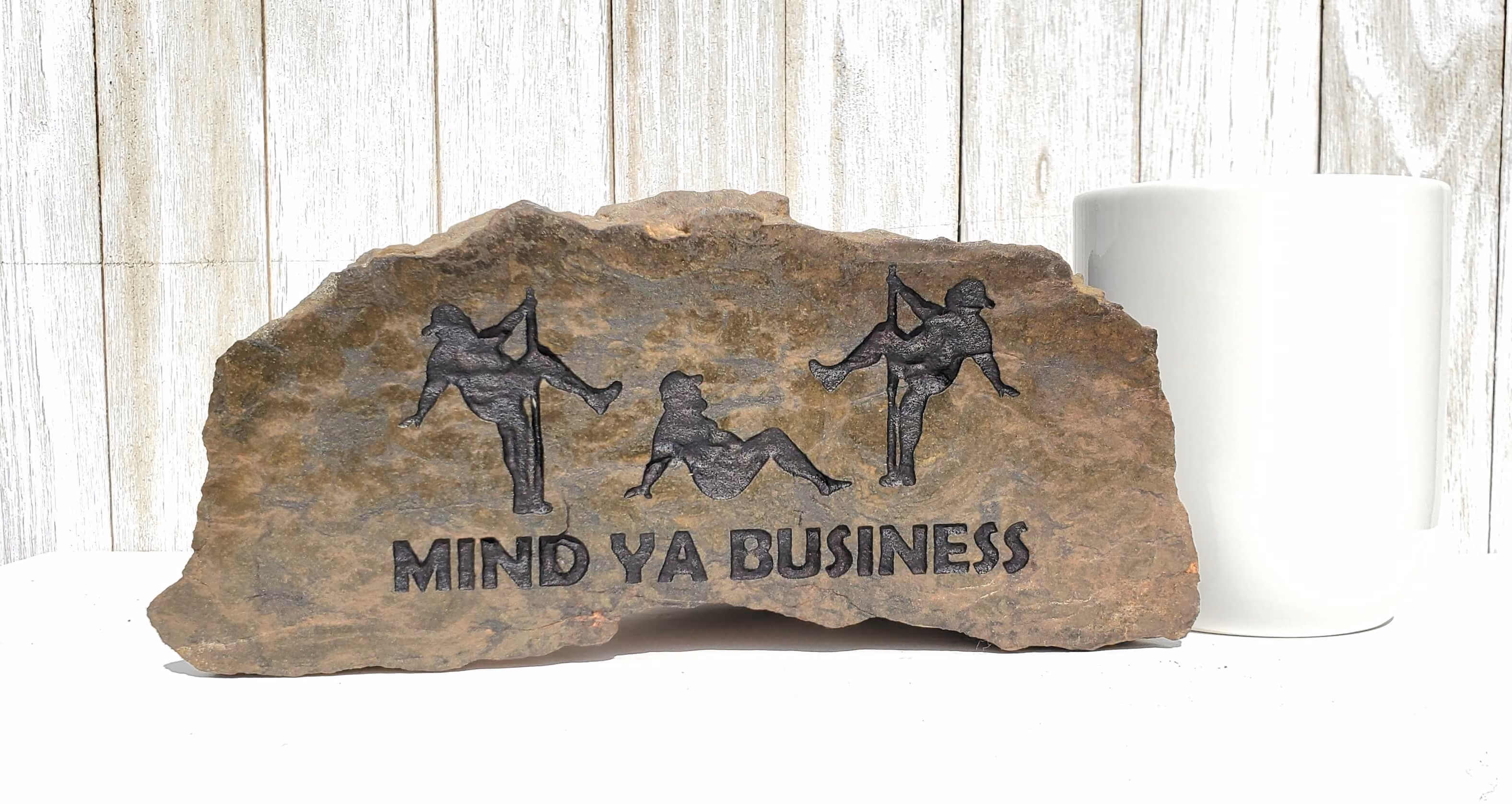 Engraved Stone with mind ya business sign