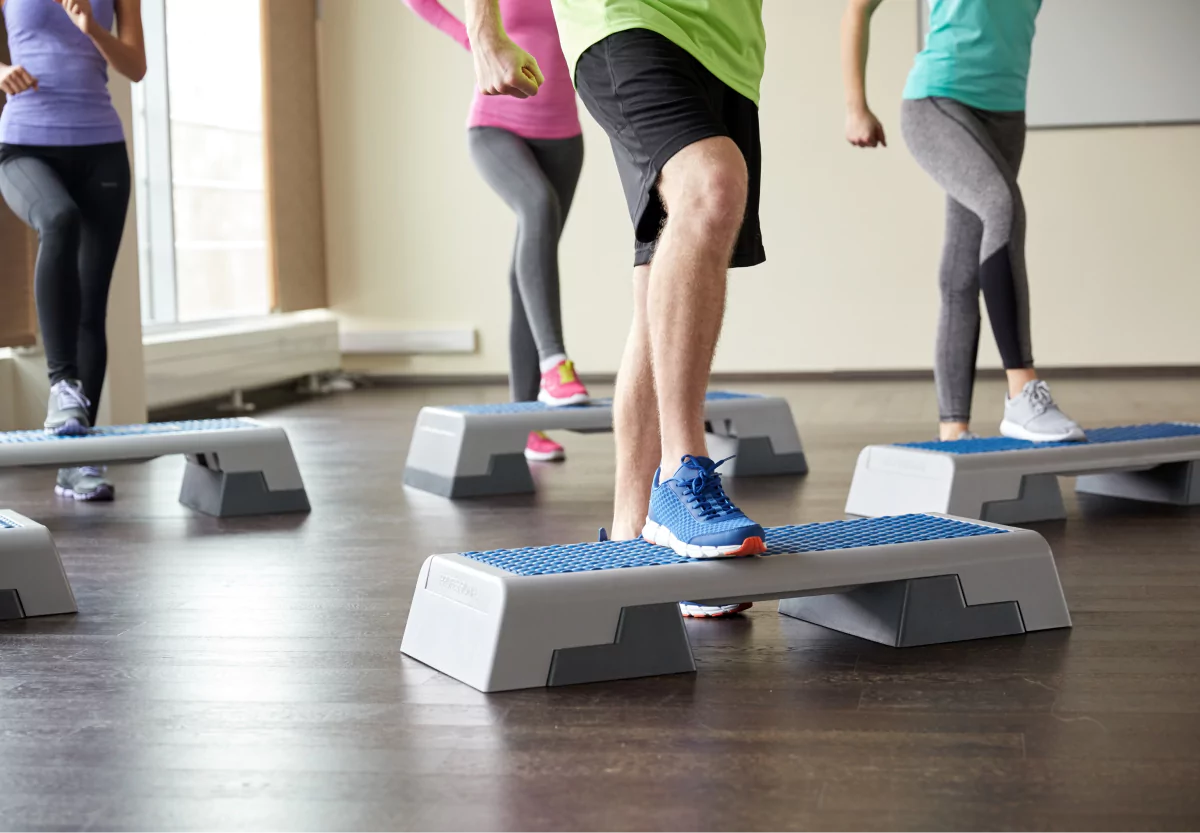 people in a class doing step ups