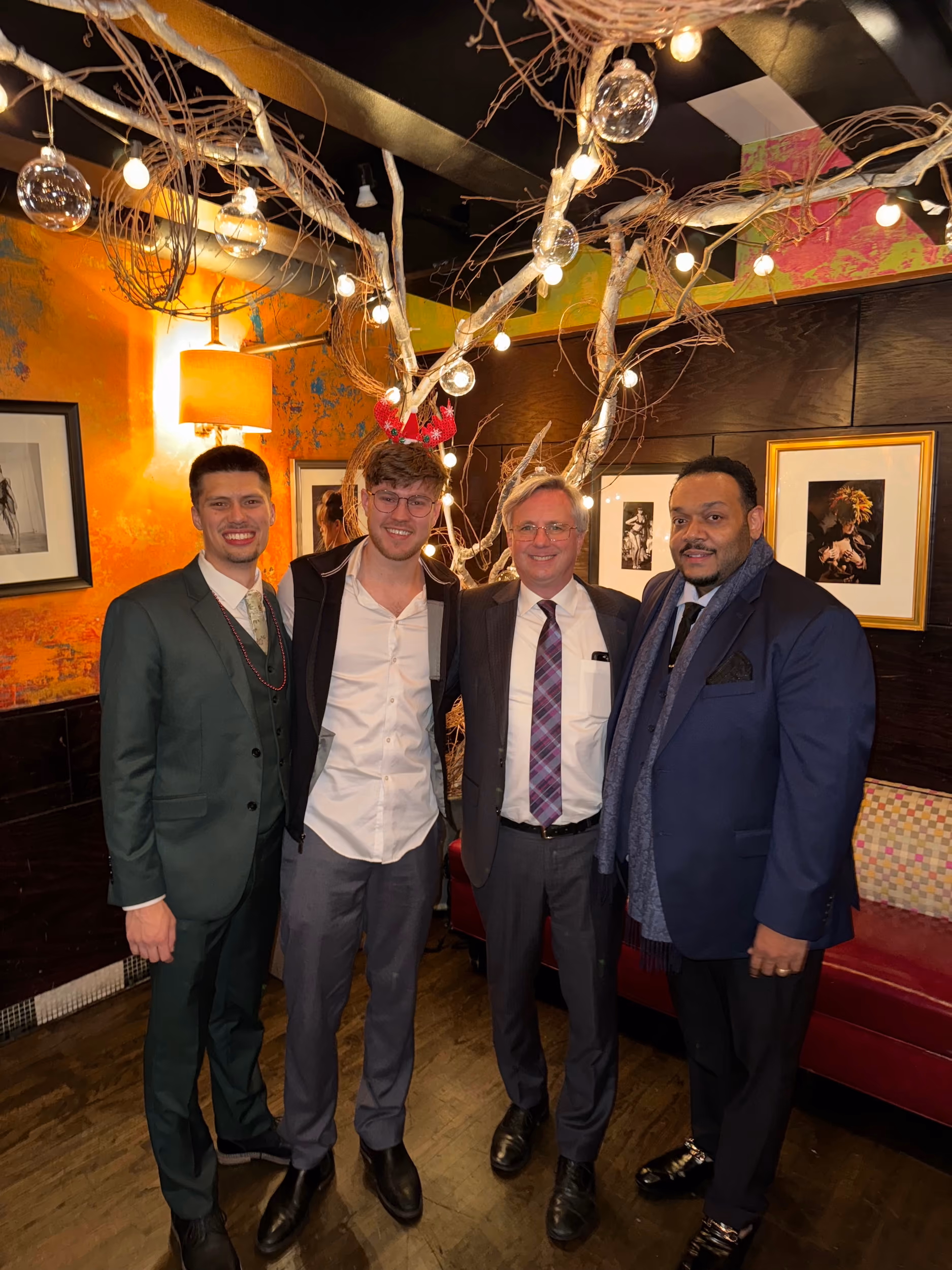 Gabriel Burch and Chase Pickett, founders of Precision Social, stand with a client at Carnivale Restaurant in Chicago.