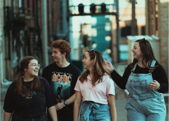 four young people walking and talking