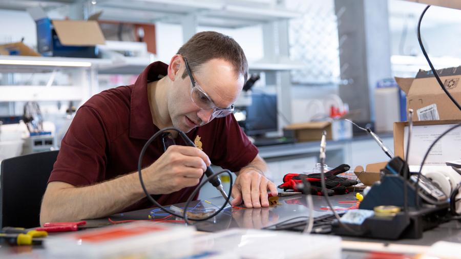 Konrad Rykaczewski works in his lab, photographed for The real reason we sweat. Photograph: Erika Gronek / ASU.