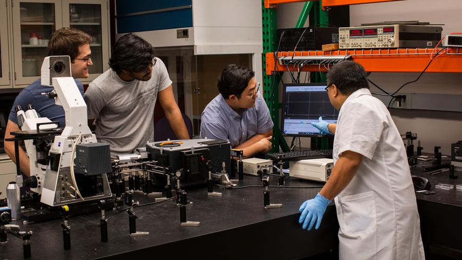 Sui Yang (right), an assistant professor of materials science and engineering in the School for Engineering of Matter, Transport and Energy, part of the Ira A. Fulton Schools of Engineering at Arizona State University, in his lab with graduate students (right to left), JaeWoo Park, Abhishek Saji Kumar and Jahan Bruce. Yang received the 2026 National Science Foundation Faculty Early Career Development Program (CAREER) Award to pioneer a new way to develop optical materials. Photographer: Roger Ndayisaba/ASU
