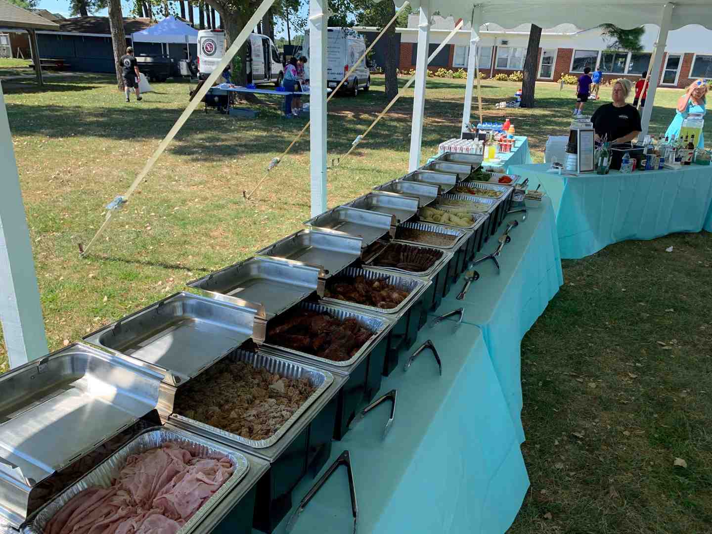 A diverse catering spread featuring on-site grilled food, a buffet line, and neat food stations - catering and bar service near me A diverse catering spread featuring on-site grilled food, a buffet line, and neat food stations - catering and bar service near me