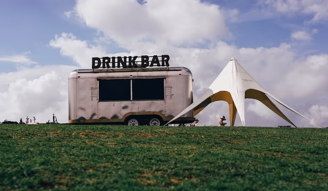 A unique mobile bar, such as a converted horse trailer or vintage truck, decorated for an event - catering and bar service near me