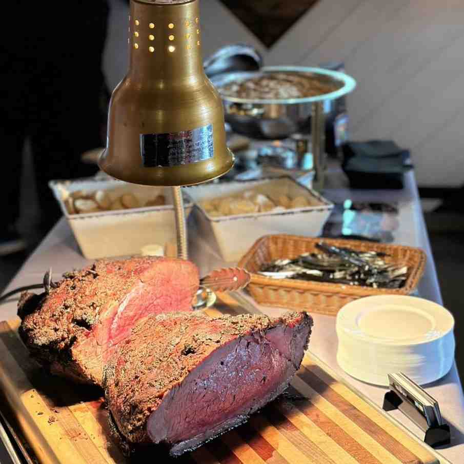 Delicious spread of BBQ meats and classic sides on a buffet table - backyard barbecue catering near me