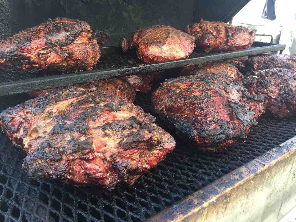 Close-up on slow-smoked brisket with a visible pink smoke ring - backyard barbecue catering near me