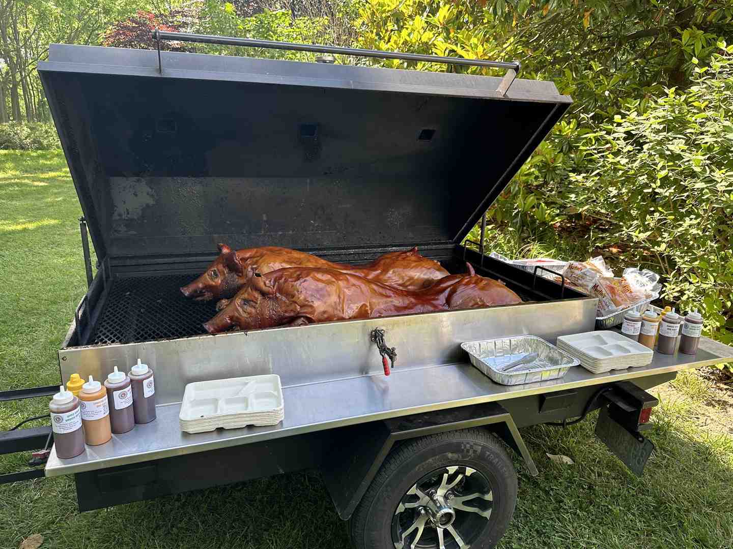 chef grilling on-site with smoker and buffet setup at outdoor event