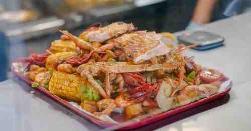 Fresh lobsters steaming on-site at a traditional outdoor clambake seafood feast