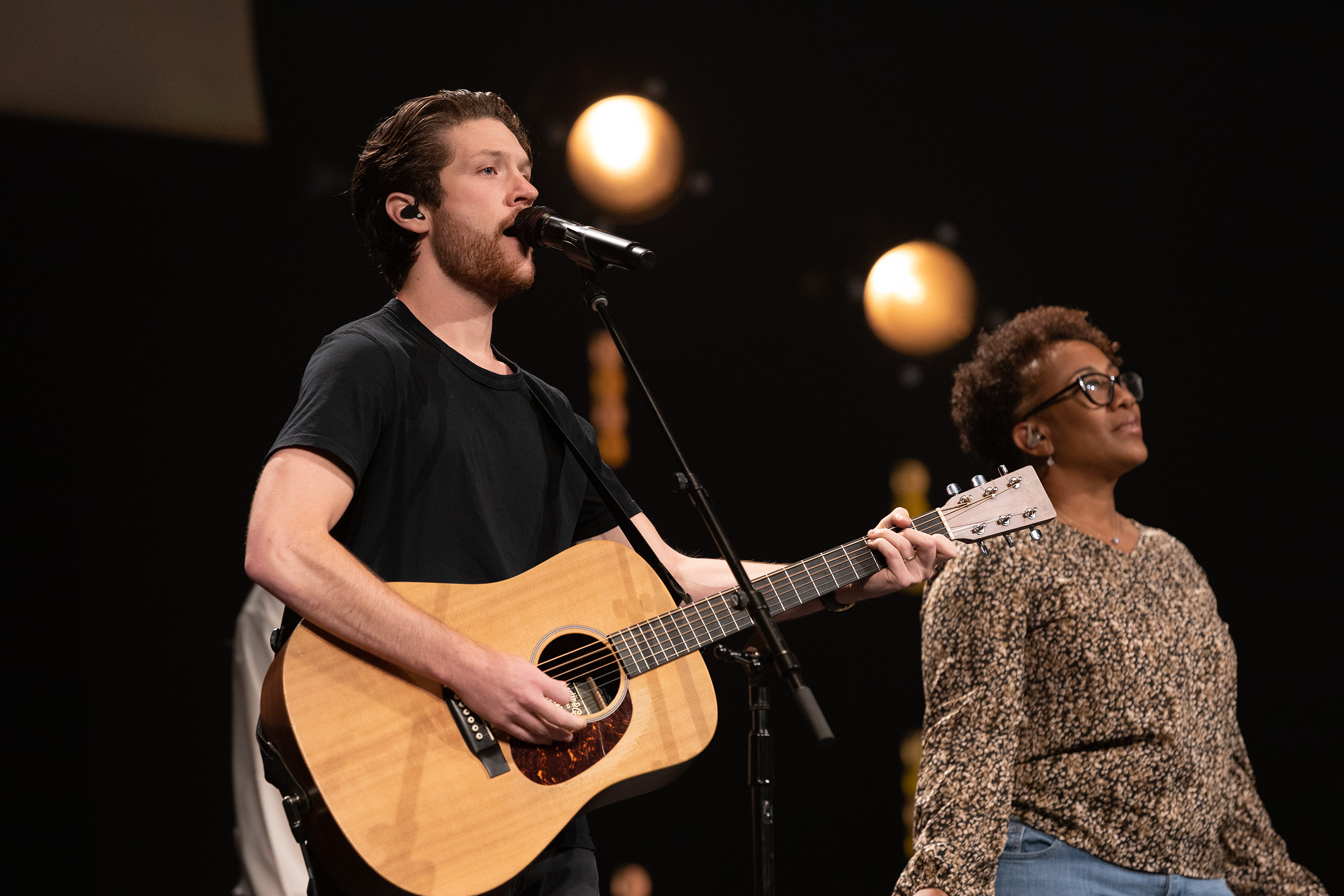 Man leading worship playing guitar