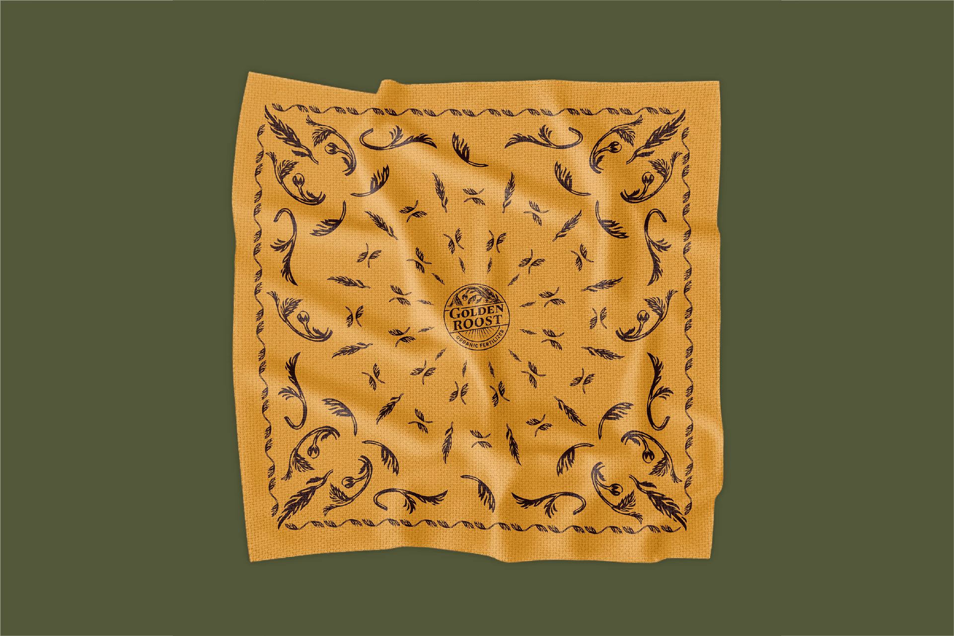 Mustard yellow cloth with black botanical swirl patterns and the text 'GOLDEN ROOST ORGANIC FERTILIZER' centered.