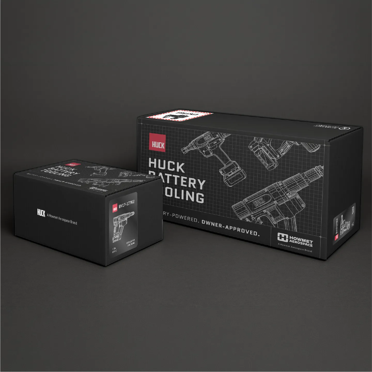 Two black Huck Battery Tooling boxes with tool illustrations on a dark background.