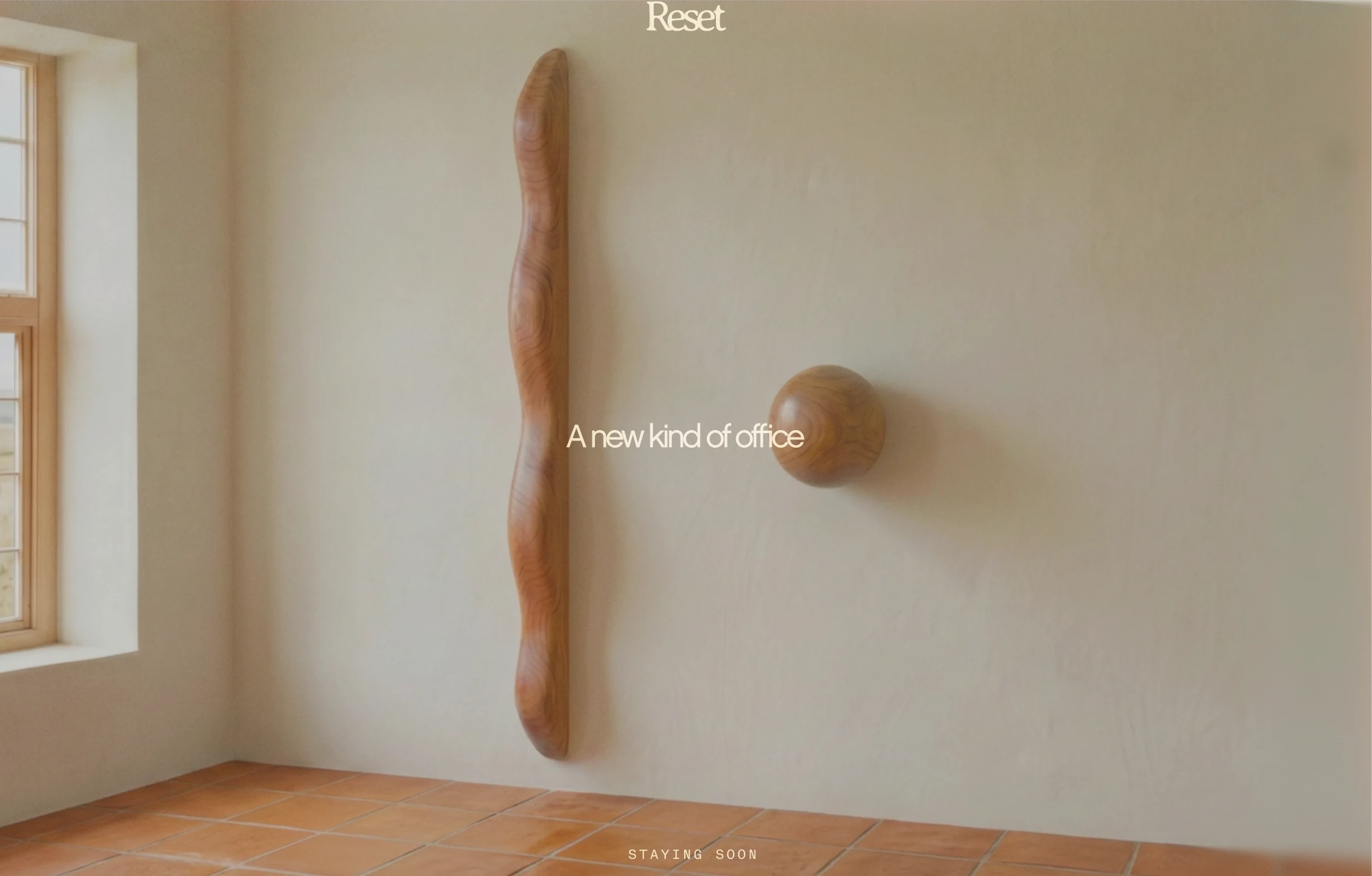 Reset landing page concept showing a warm room with sculptural wooden forms and the words A new kind of office.