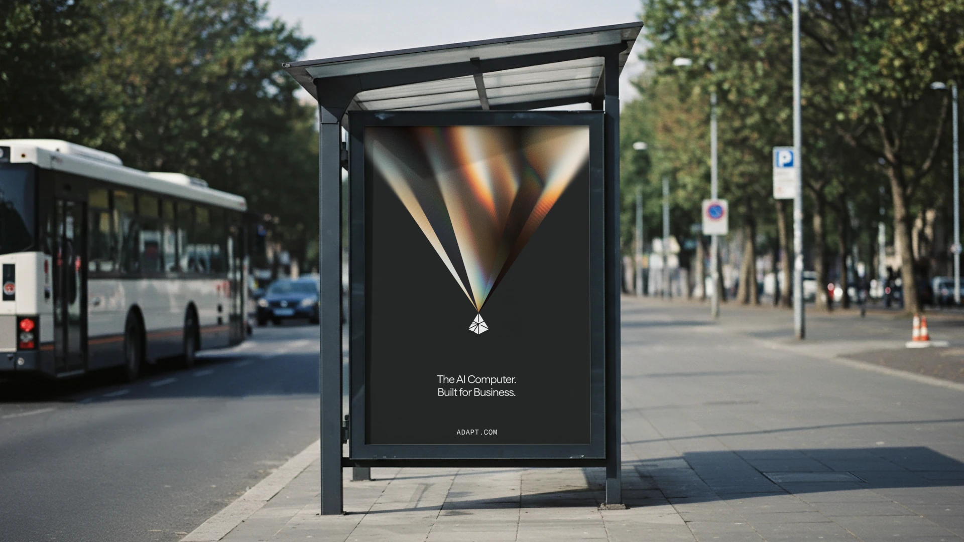 Adapt bus-stop billboard with prismatic light, the Adapt symbol, and the message “The AI Computer. Built for Business.”