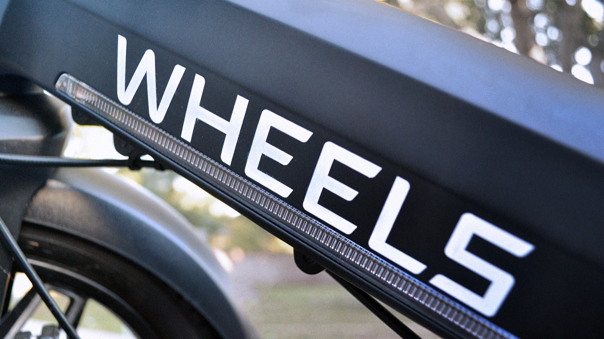 Wheels wordmark applied to the black bike frame.