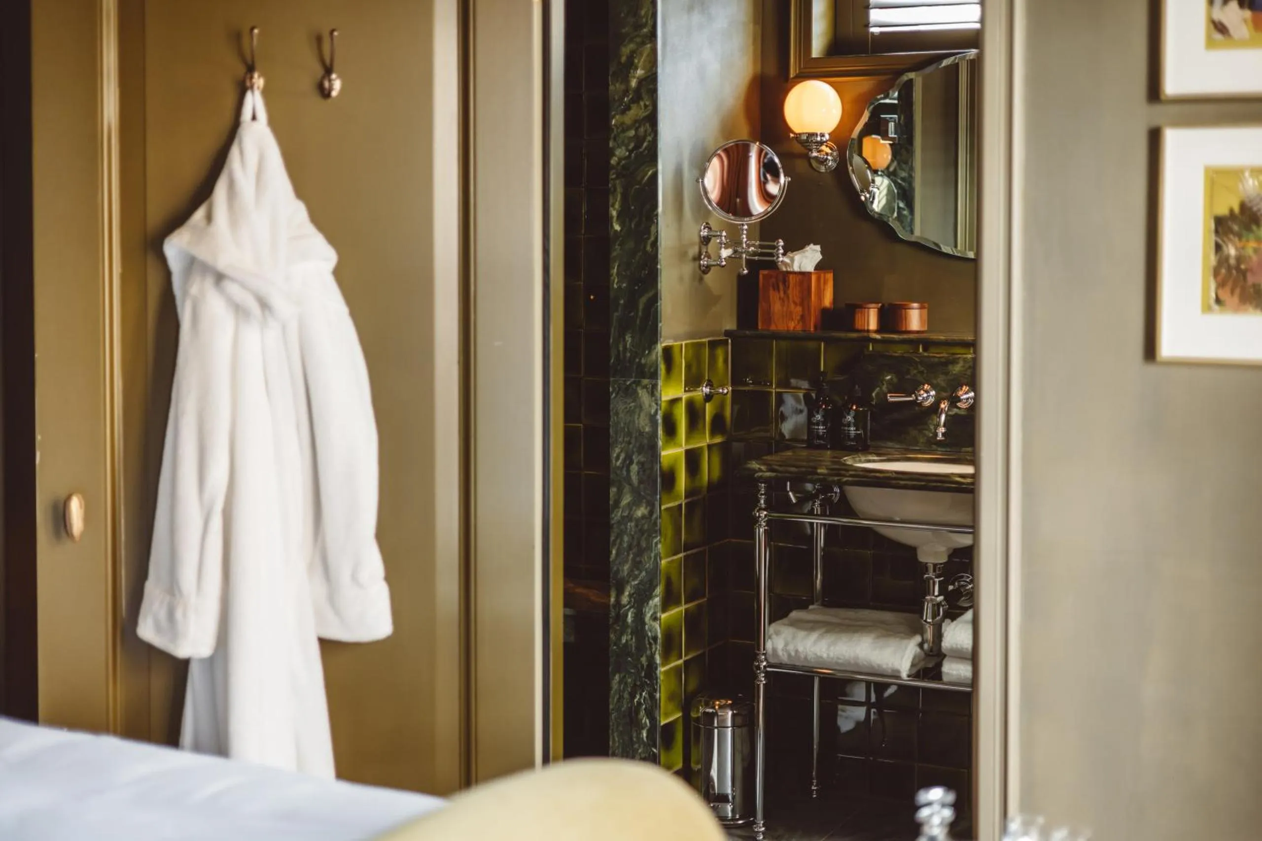 De Durgerdam bathroom with green glazed tiles, marble vanity and chrome washstand