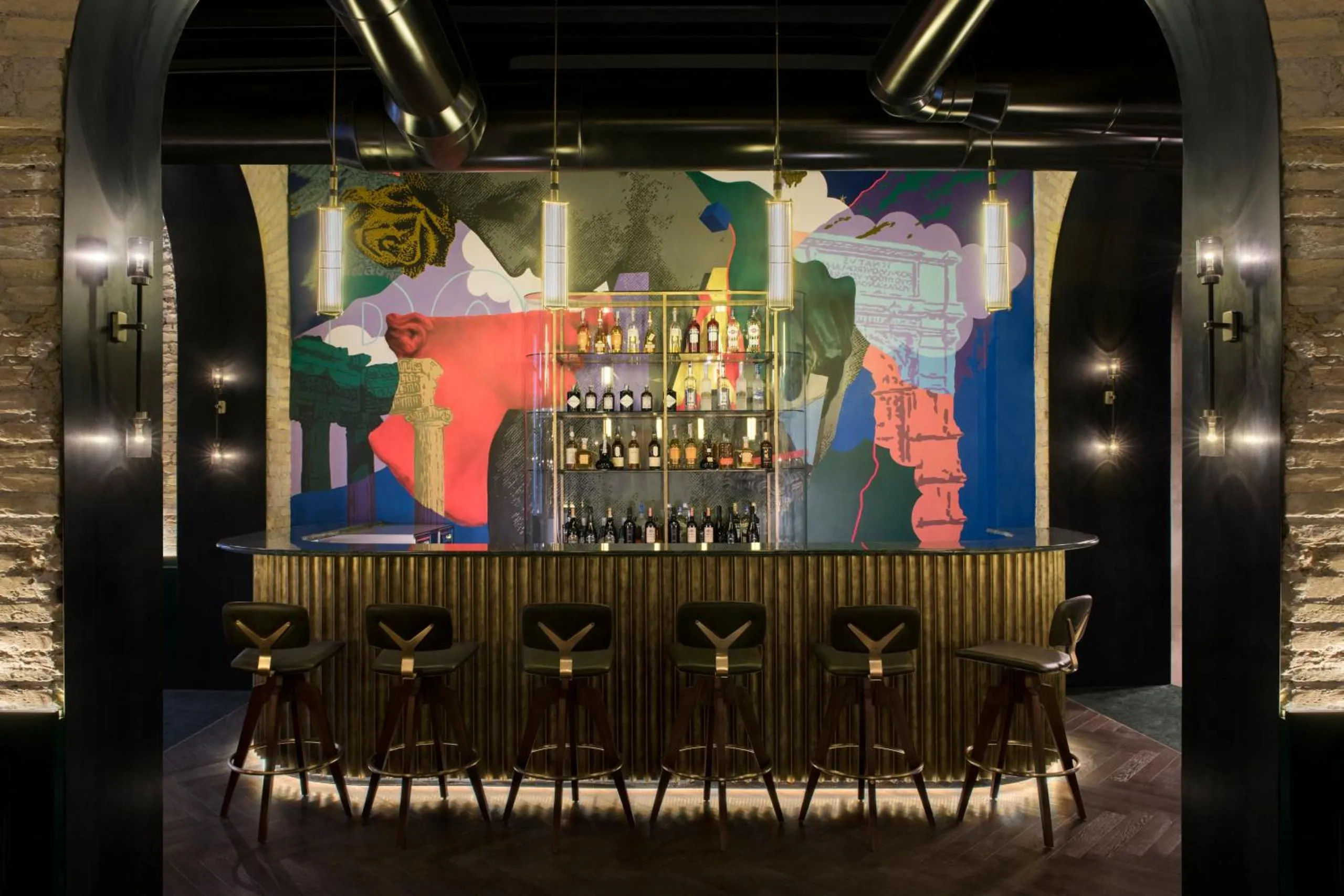 Hey Baby Bar at Chapter Roma with fluted brass counter, pop-art mural and Y-shaped stools
