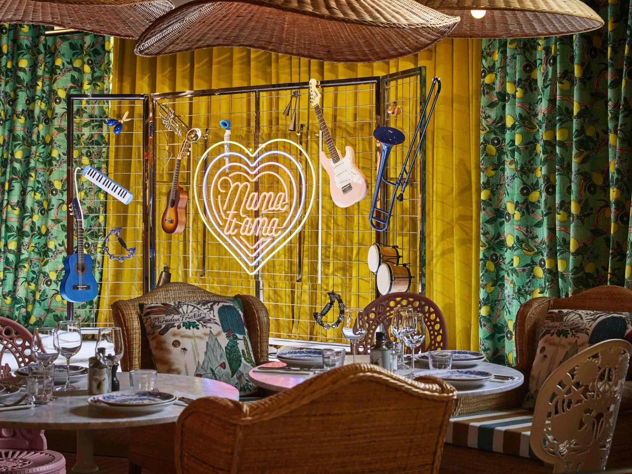 Mama Shelter Roma restaurant with lemon-print curtains, neon heart sign and musical instrument display