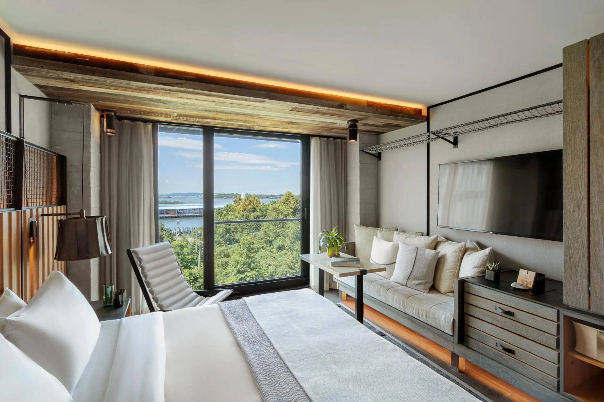 1 Hotel Brooklyn Bridge bedroom with lounge chair and floor-to-ceiling windows