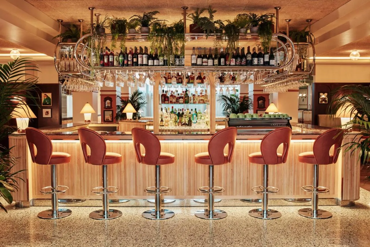 The Hoxton Shepherd's Bush boutique hotel - bar counter lined with red leather stools