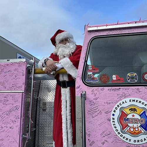 A portrait of a first responder with the American flag as a backdrop.