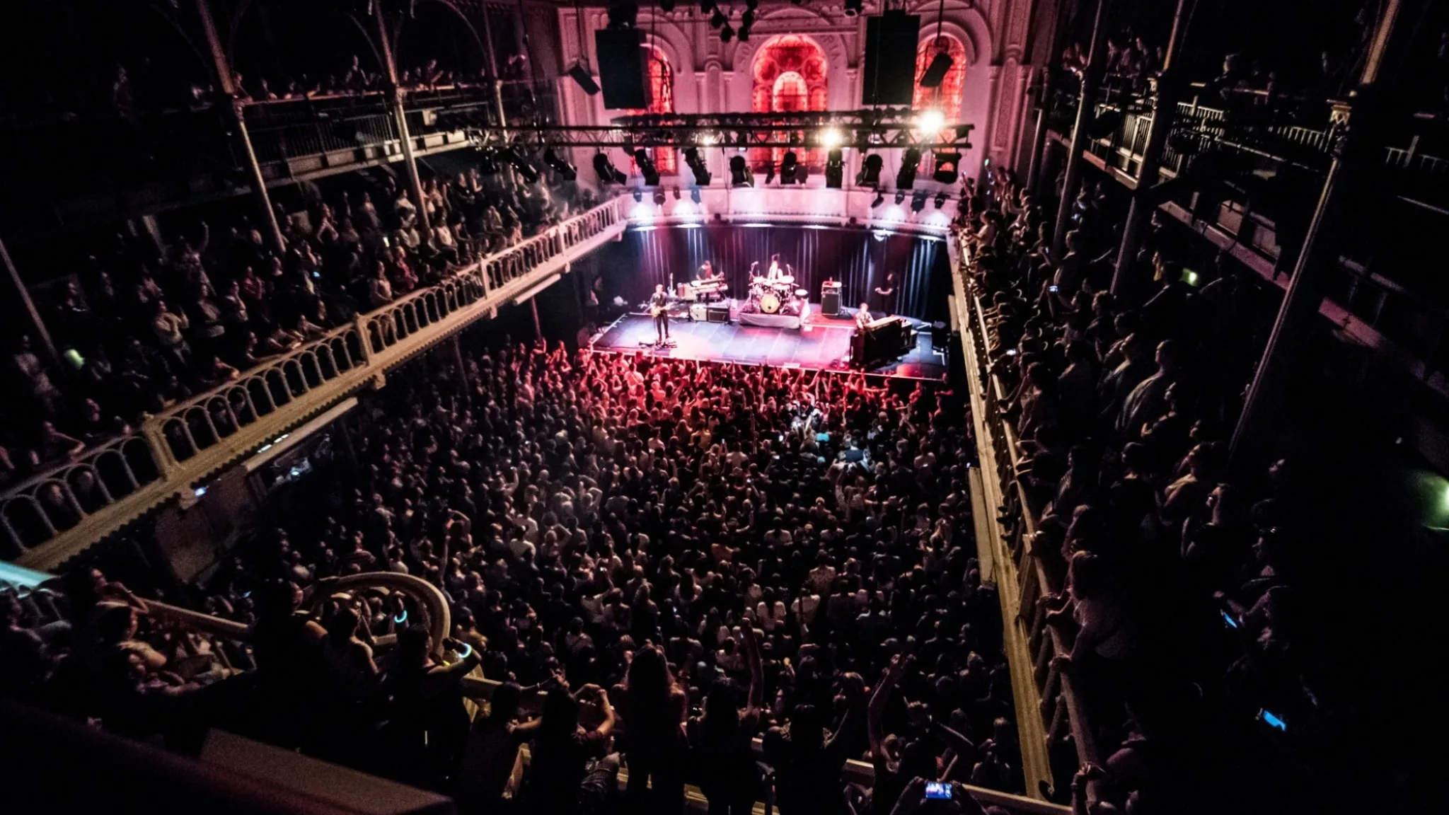 A club night at Paradiso in Amsterdam, showing the inside of the club, the main stage and the balconies around it.