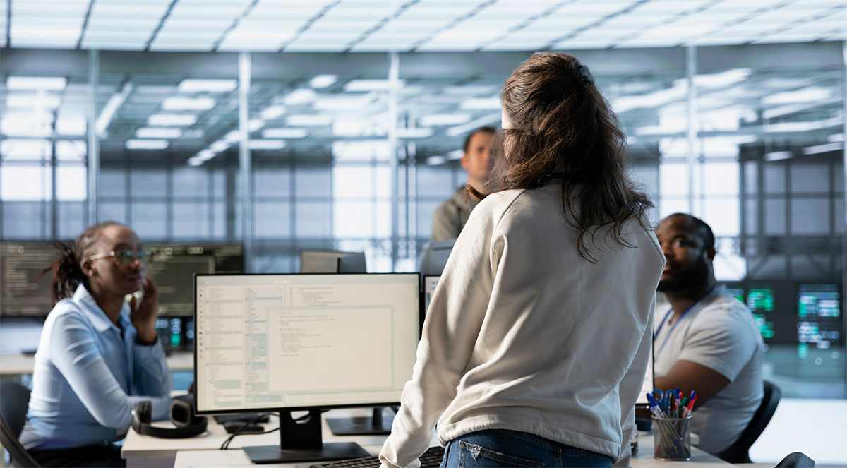 Managed security service provider team reviewing systems at a network operations center in Norfolk, Virginia
