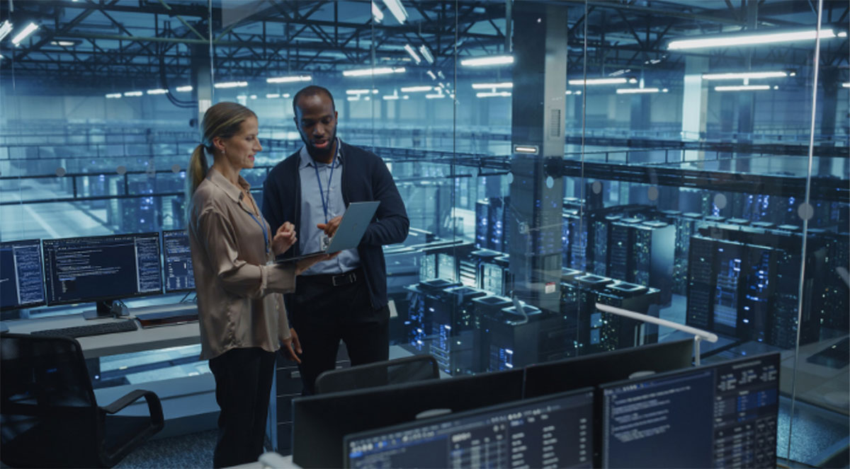 IT professionals collaborating in a data center operations facility with server infrastructure