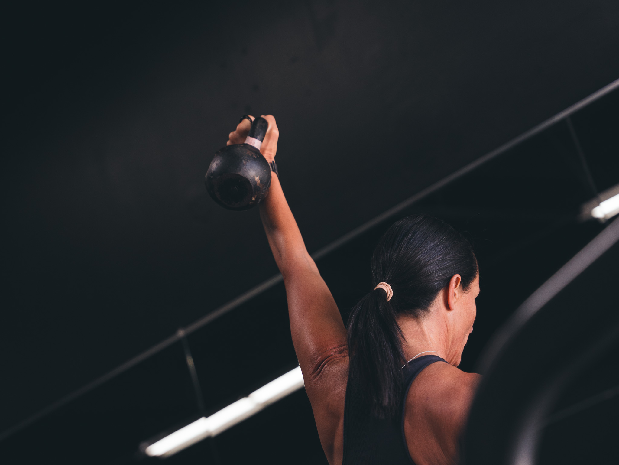 Carlsbad personal training coach guiding client through biomechanics-based dumbbell bench press at DBC Fitness San Diego