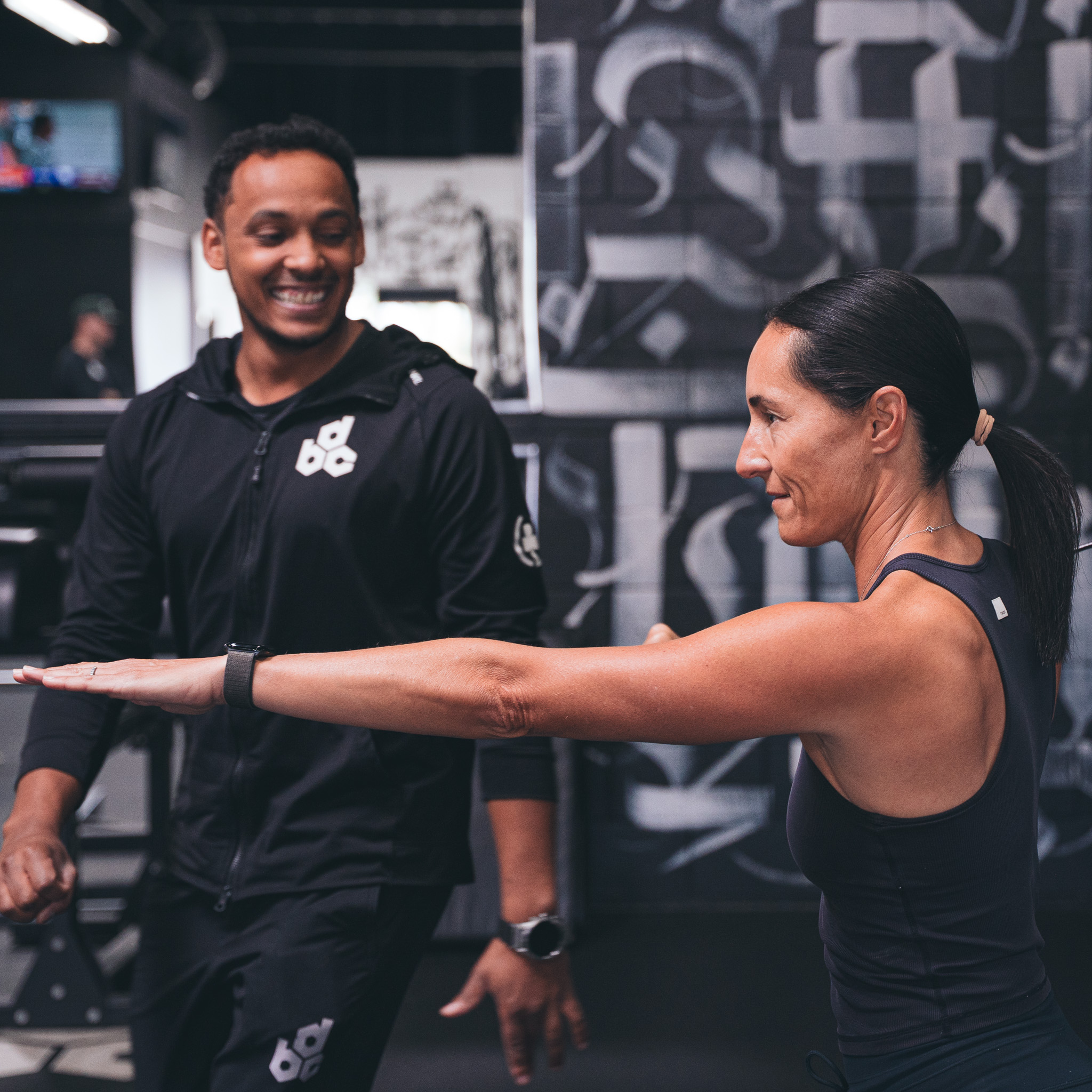 Sports performance coach in San Diego guiding athlete through mobility and alignment testing.