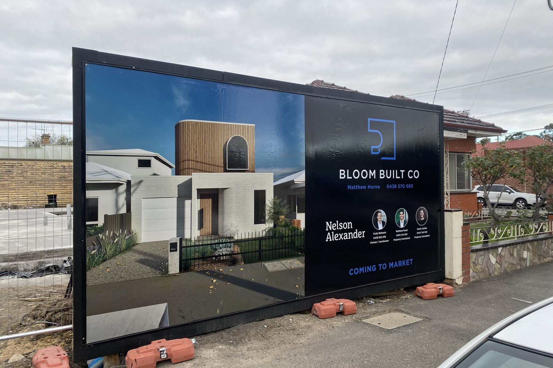 Bloom Built Co construction site hoarding with printed project imagery