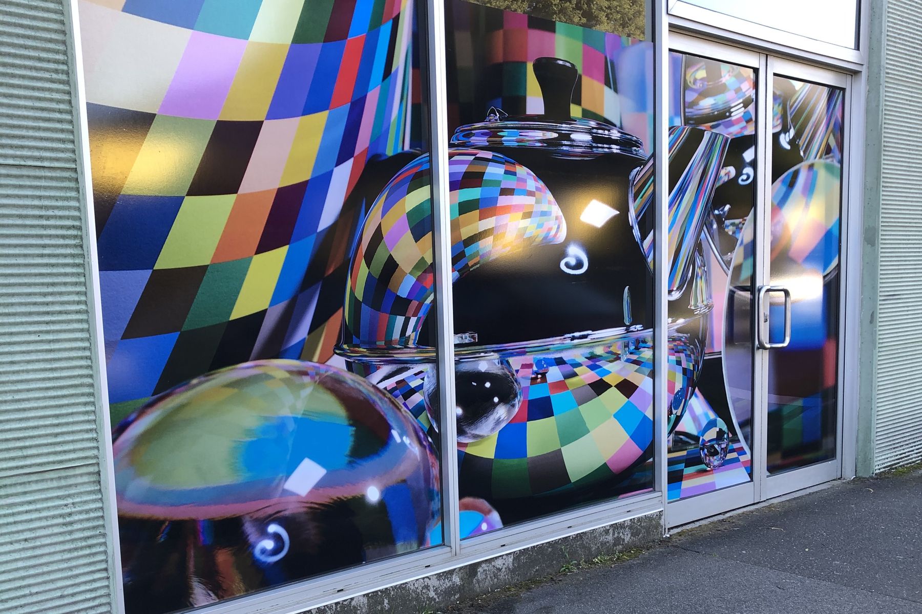 Large-format printed shopfront window graphics with a colourful bubble pattern