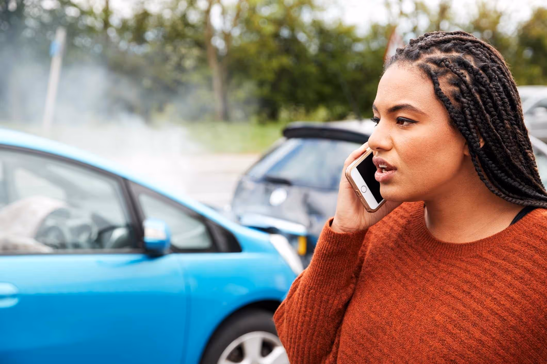 Woman calling for help after a car crash, representing the need for a Baytown car accident lawyer.