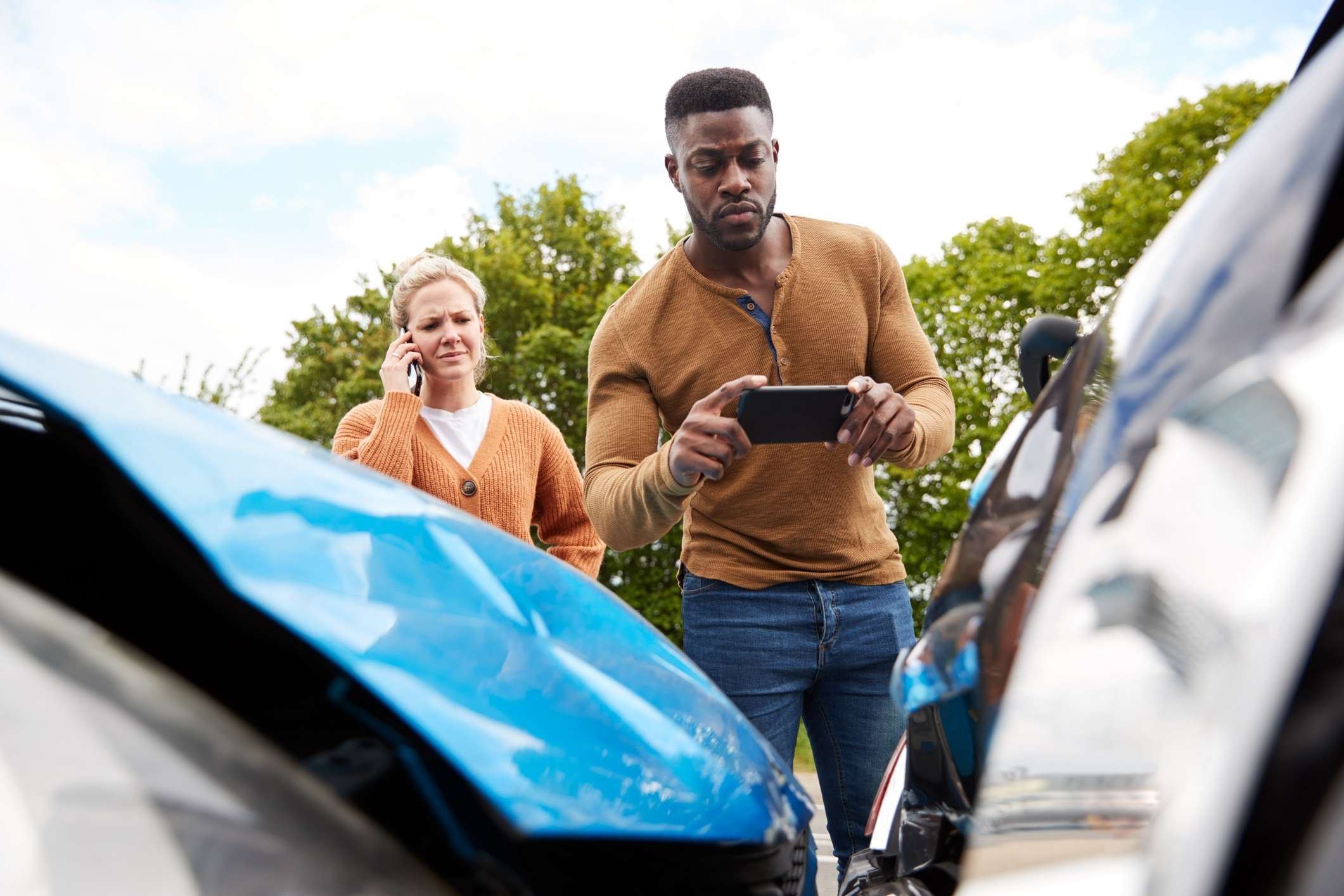Man photographs car damage after crash in Texas for insurance claim with Rosenberg car accident lawyer.
