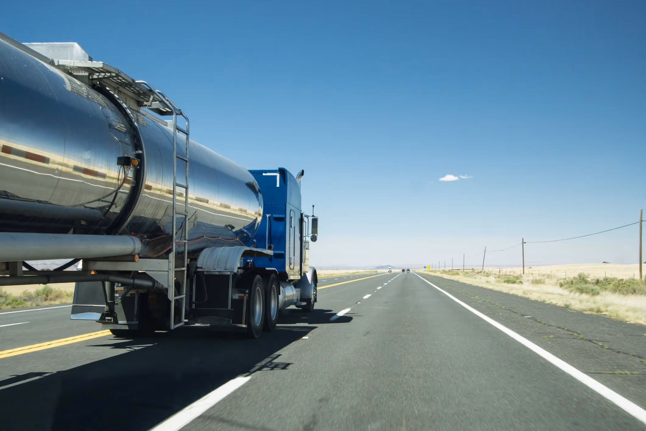 Silver tanker truck on Texas highway, illustrating risks handled by a La Porte truck accident lawyer.