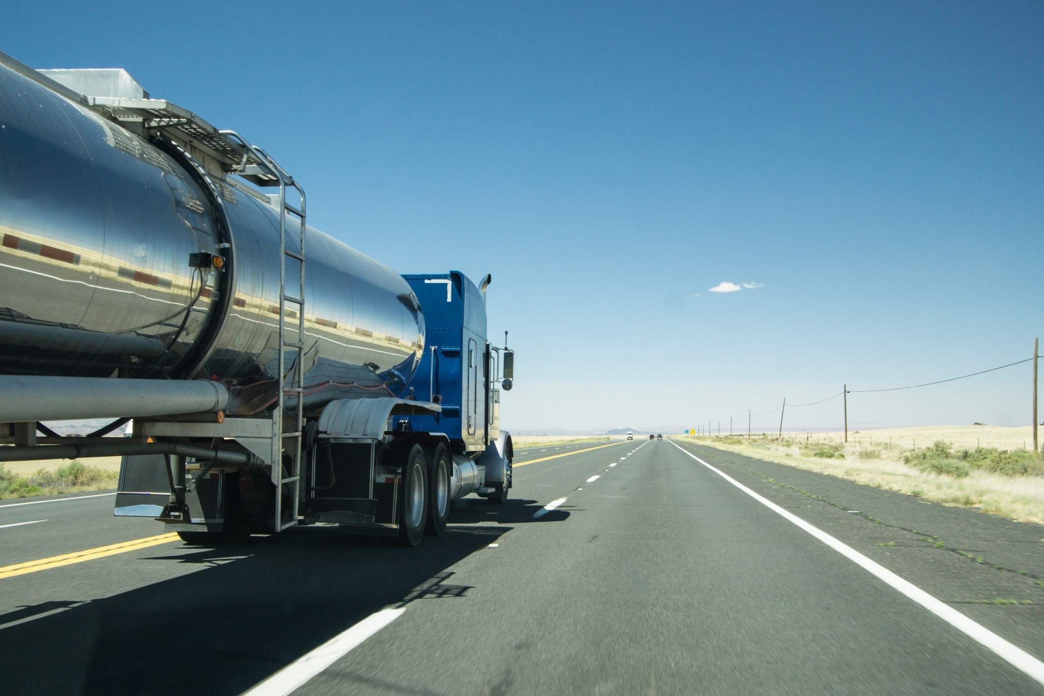 Silver tanker truck on Texas highway, illustrating risks handled by a La Porte truck accident lawyer.