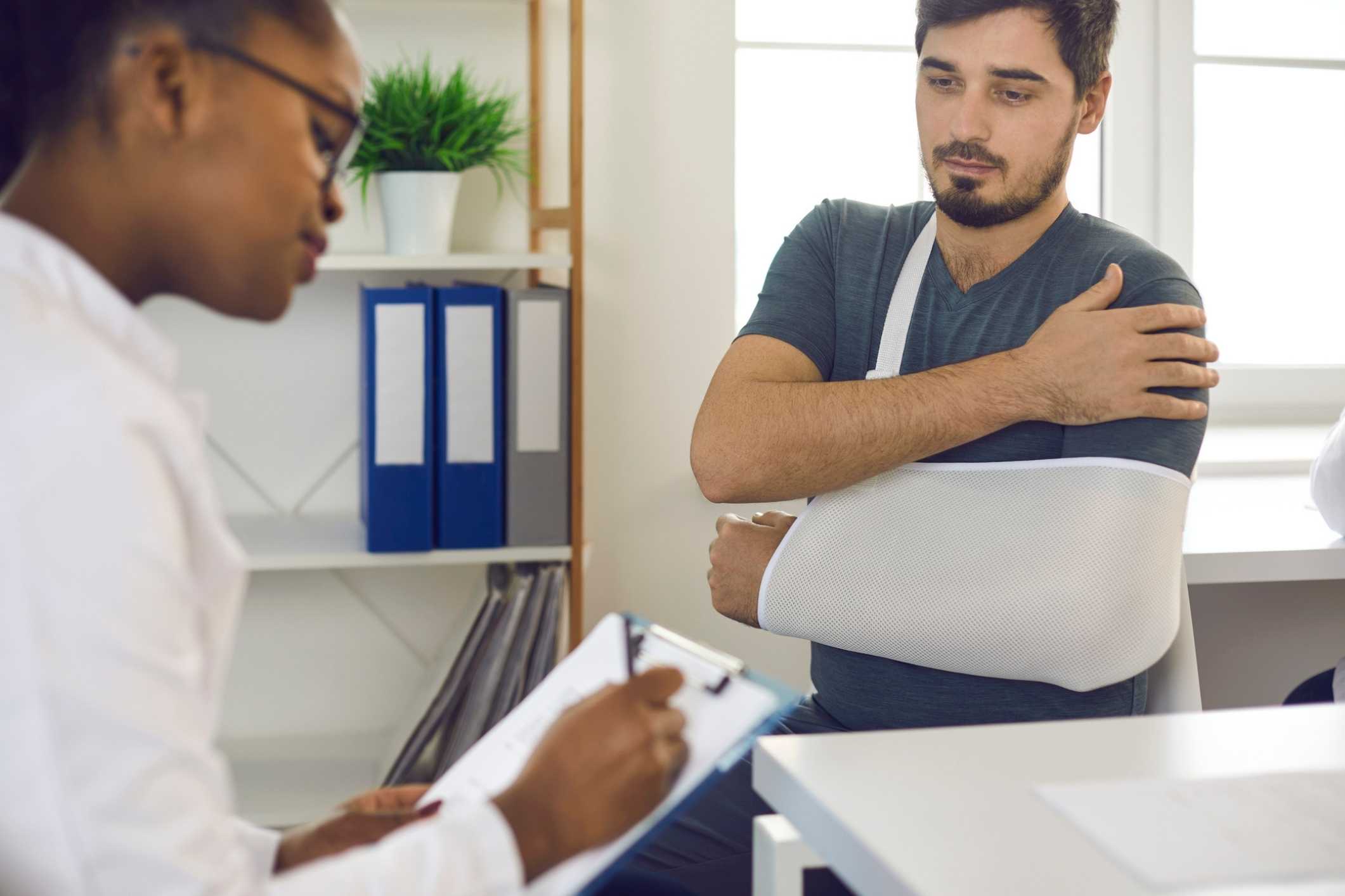 Patient with arm injury discussing treatment after an accident in a Humble personal injury case.