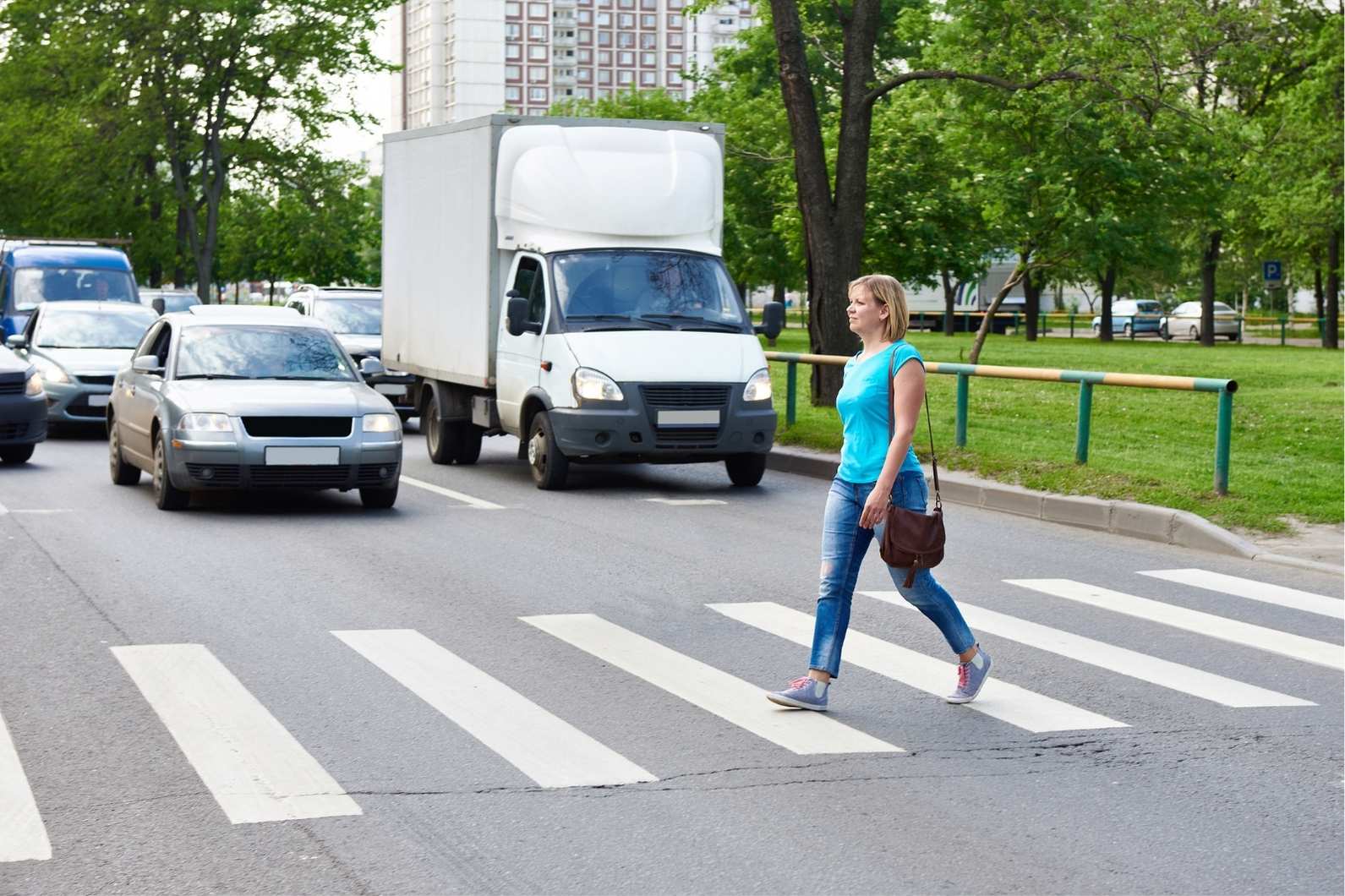 Woman in a crosswalk after a collision that may require a Houston pedestrian accident lawyer.