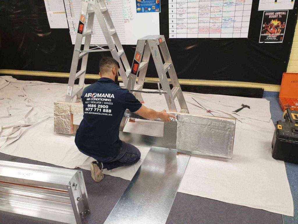 Airomania technician at work on ducting