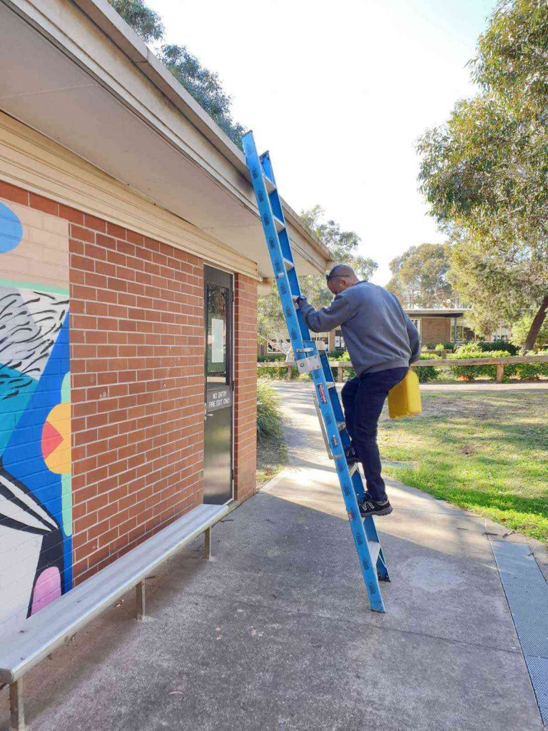 Airomania technician at work on ladder