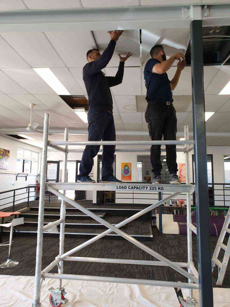 Two Airomania technicians at work on scaffolding