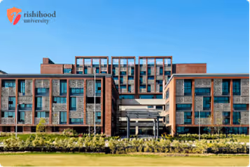 Modern brick and glass campus building of Rishihood University under clear blue sky.