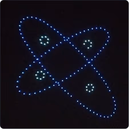 Blue LED light pattern depicting an atomic structure with four orbiting electron paths and electrons represented by clustered lights.