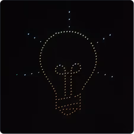 Light bulb icon made of small illuminated dots on a black background.