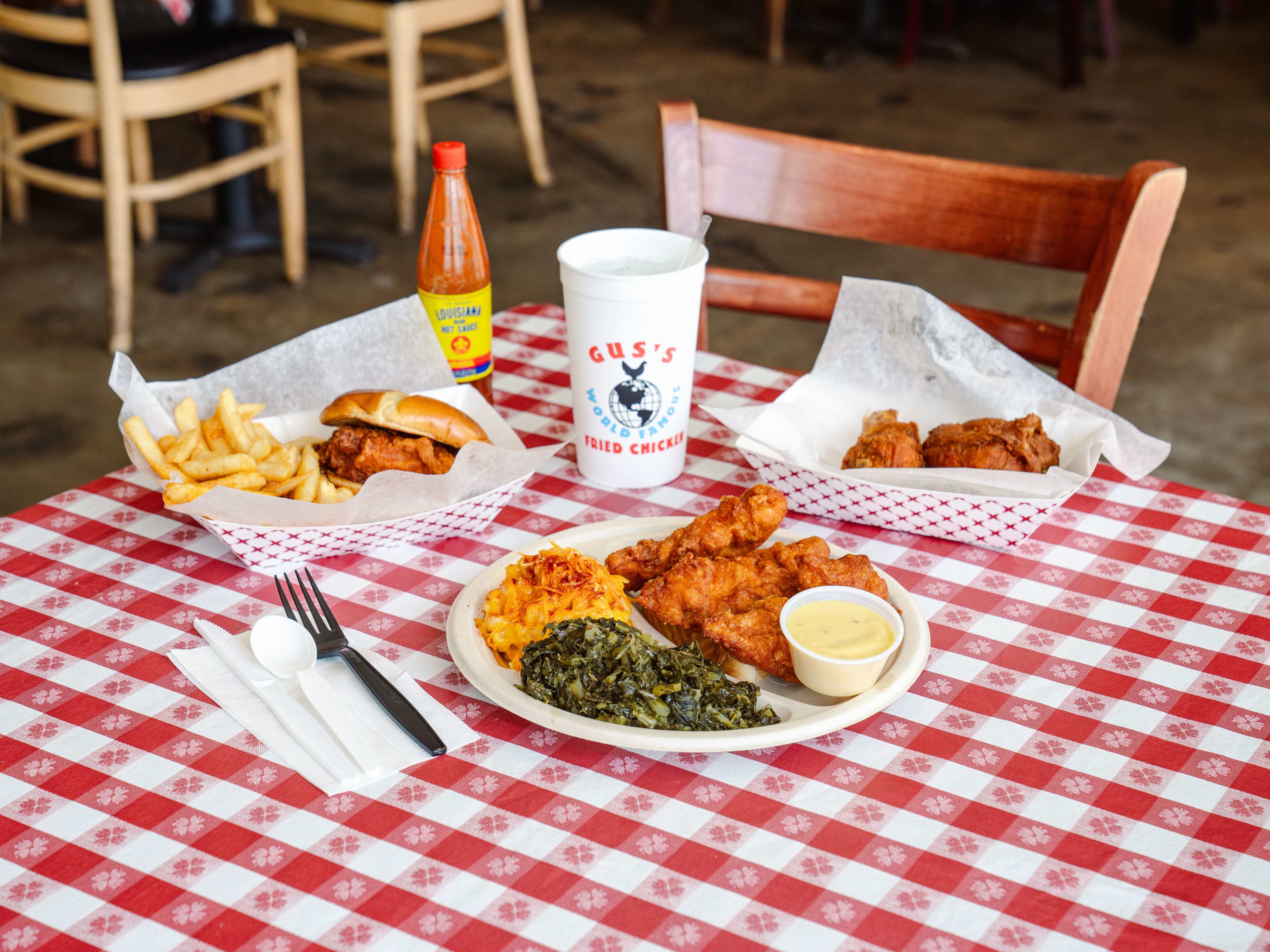 spread on checkered table with chicken, cub, greens, mac&cheese.