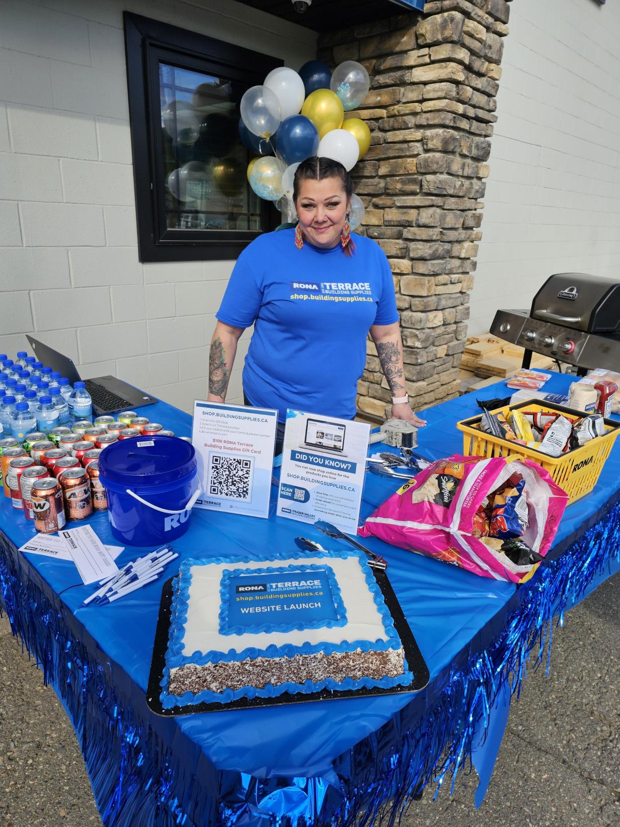Woman with black hair and blue shirt standing at counter with point of sale system