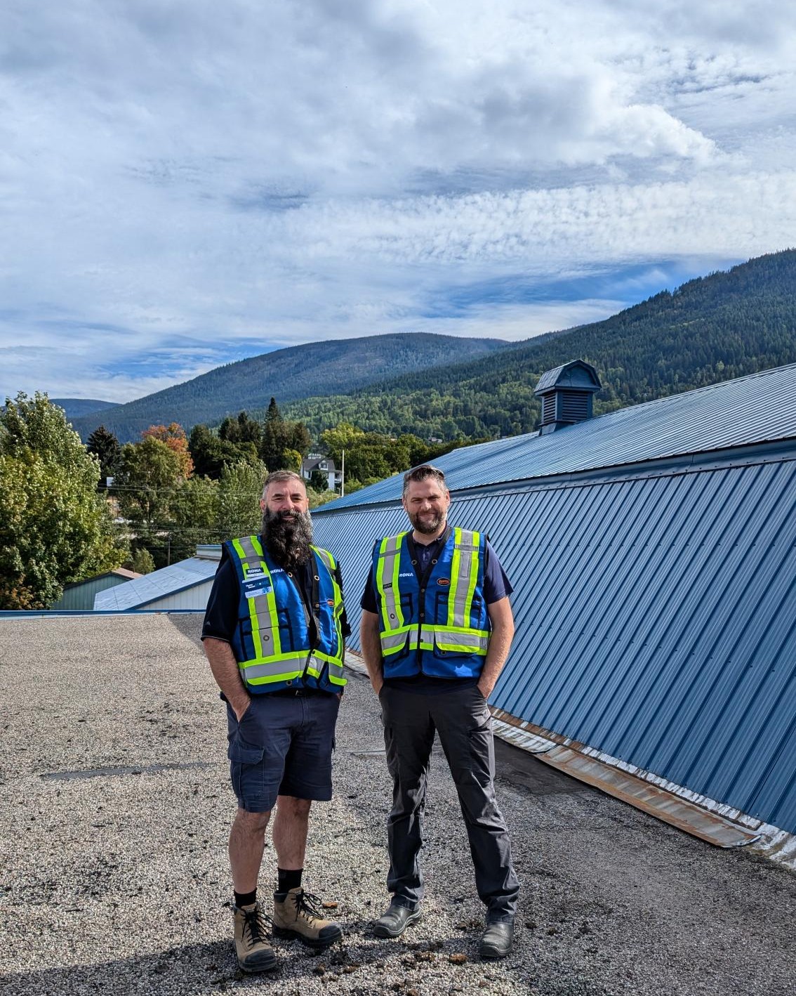 Man with beard standing with arms folded inside hardware store