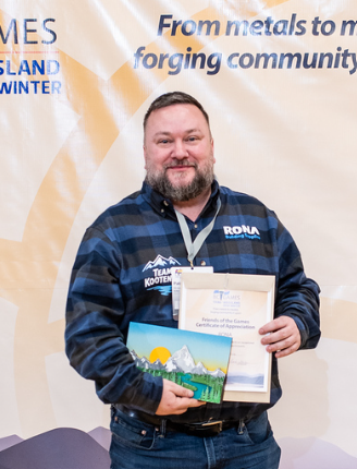 Man wearing hi-vis vest and black baseball cap standing behind counter.