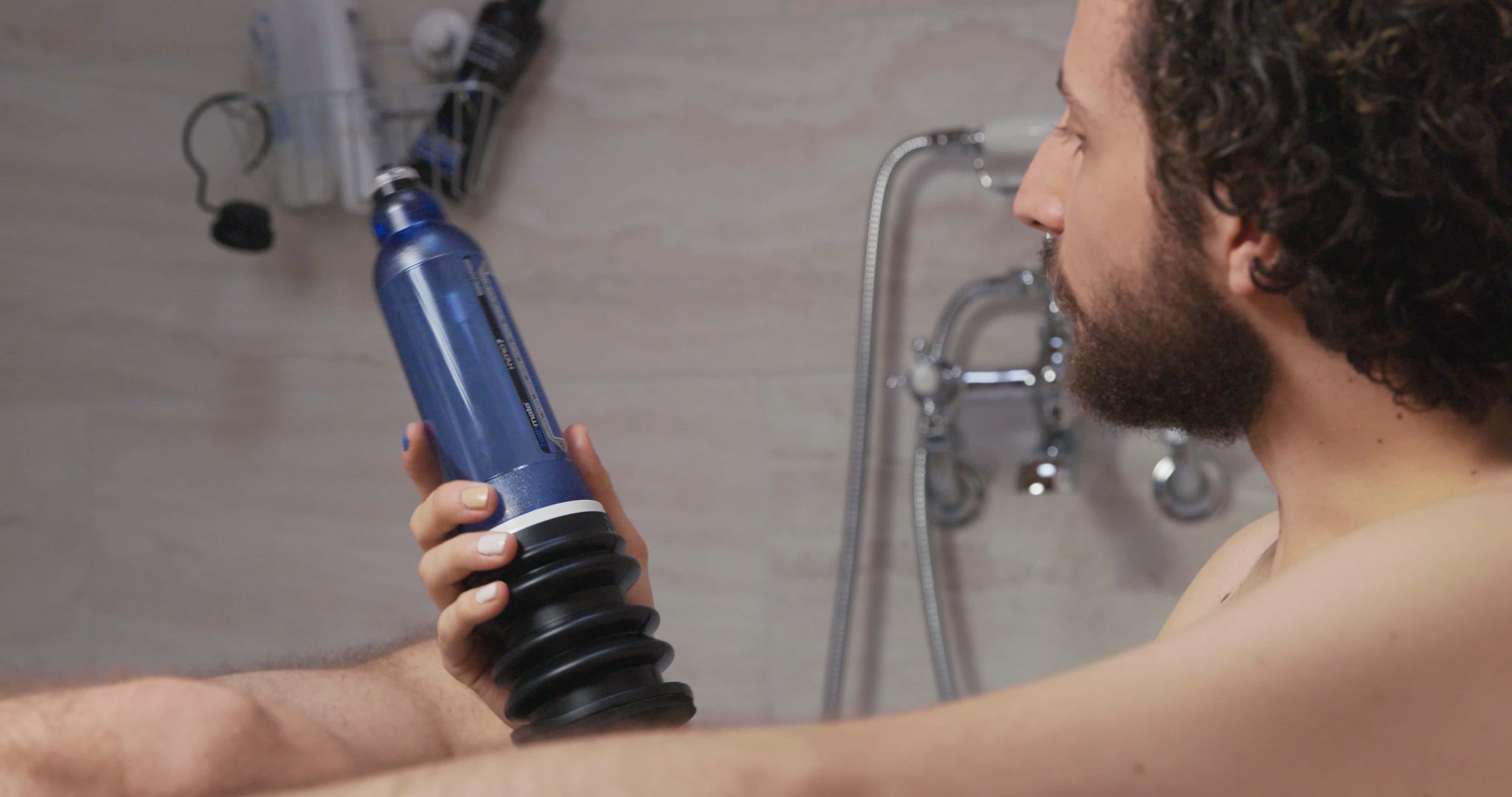 Man with penis pump in bath