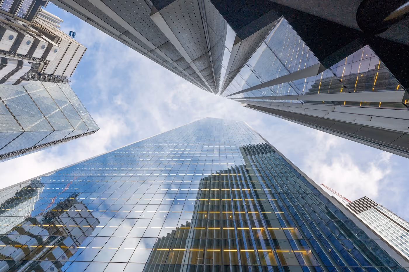 A view looking up at modern buildings and the sky in Central London.
