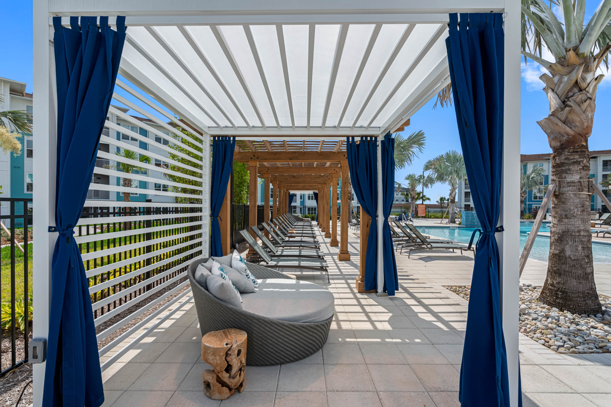 Apex Posner Park poolside cabana with curtained pergola